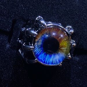 Claws Holding Blue and Yellow Eyeball Ring